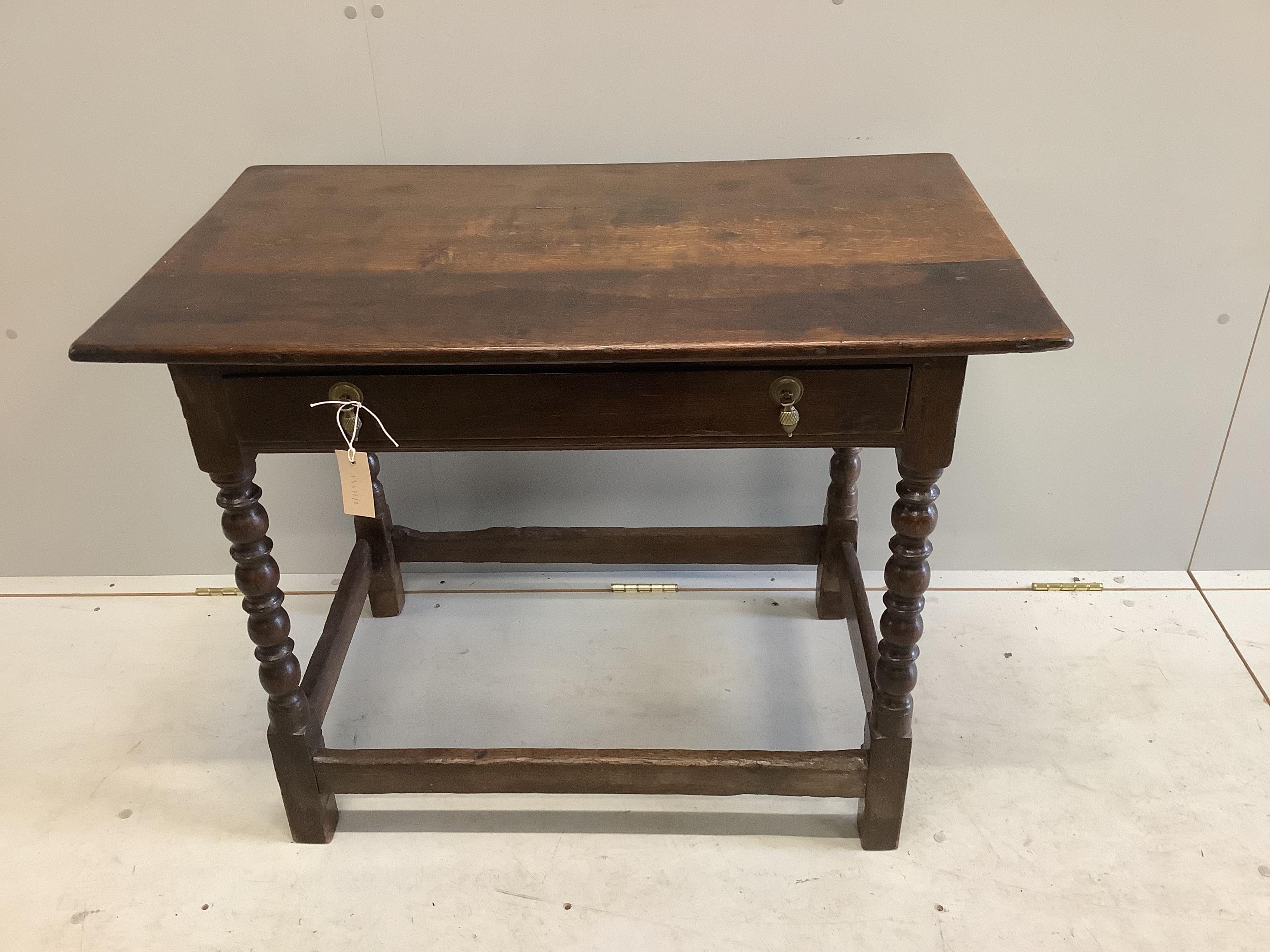 A 17th century Cromwellian rectangular oak single drawer bobbin leg side table, width 91cm, depth 54cm, height 71cm